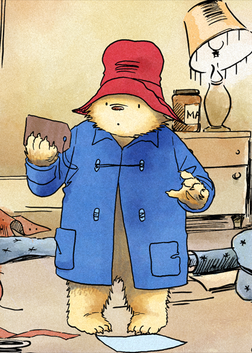 Paddington looks at the tag he was found with